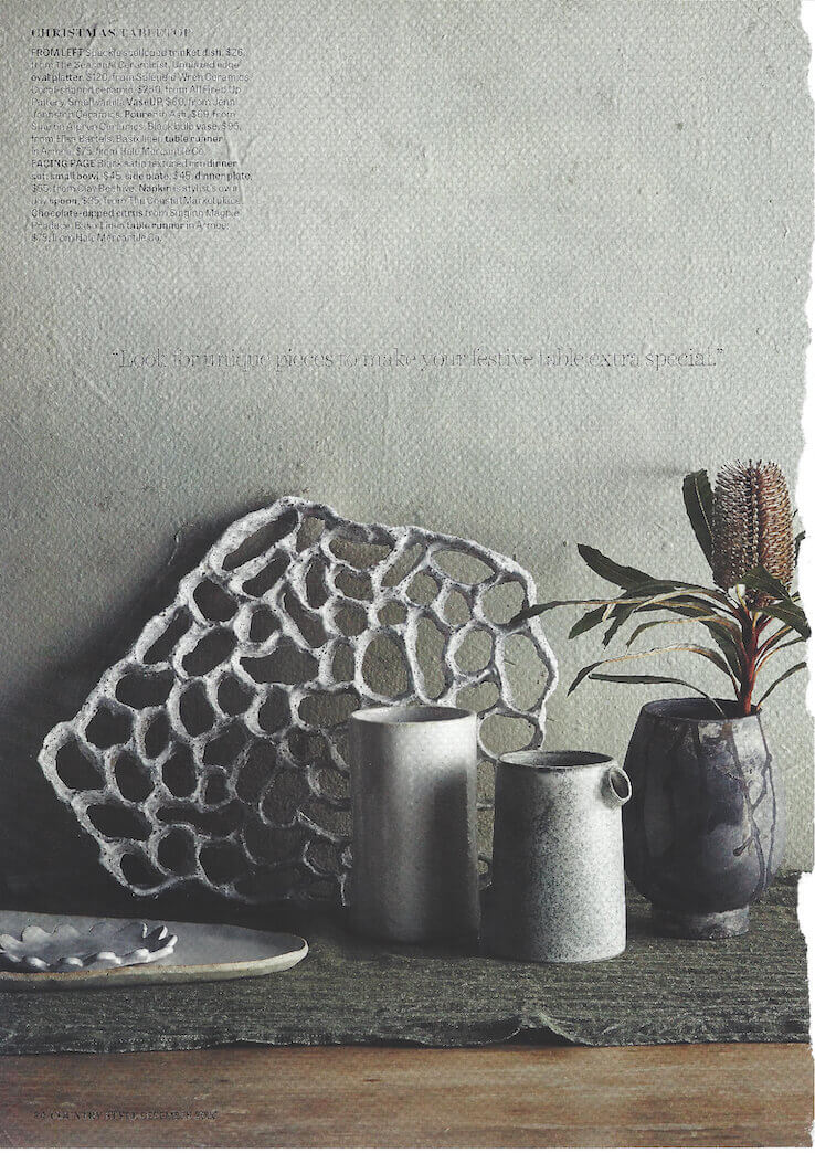 Country style magazine page with ceramic artwork and vases